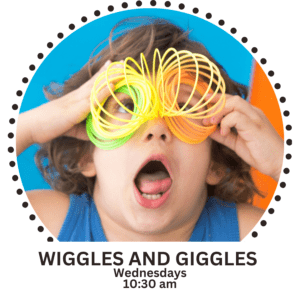 Toddler playing with plastic slinky putting it up to her eyes and looking through it